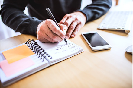 Close up of man writing notes in, a Business Photo by HalfPoint