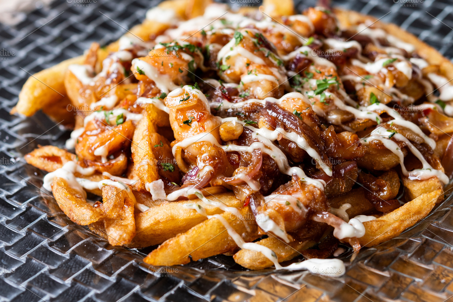 Loaded french fries with chicken, caramelized onion and sauce served on glass p, a Food & Drink Photo by etorres69