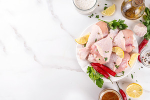 Fresh raw organic chicken legs, drumsticks, with spices and cond, a Food & Drink Photo by Rimma