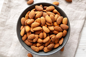 Roasted Almonds in a Bowl, top view., a Food & Drink Photo by LiudmylaChuhunova