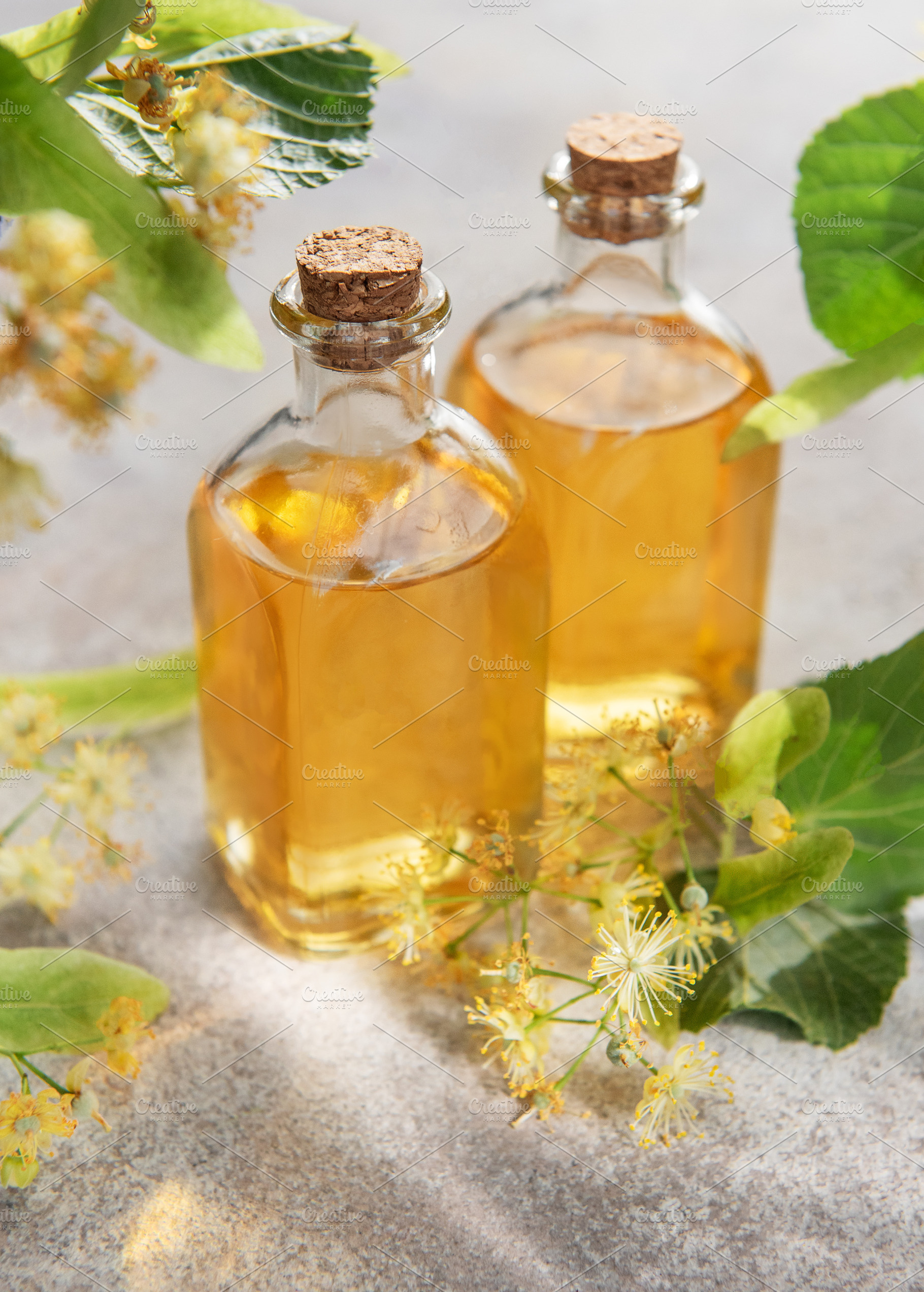Linden flower essential oil in glass bottles, a Health & Medical Photo by Olena Rudo