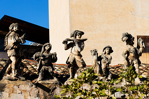 View of people and monster sculptures made of tuff in the Villa Palagonia, an Architecture Photo by Bepslabor