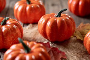Mini decorative pumpkins on rustic wooden background with autumn leaves, a Food & Drink Photo by etorres69