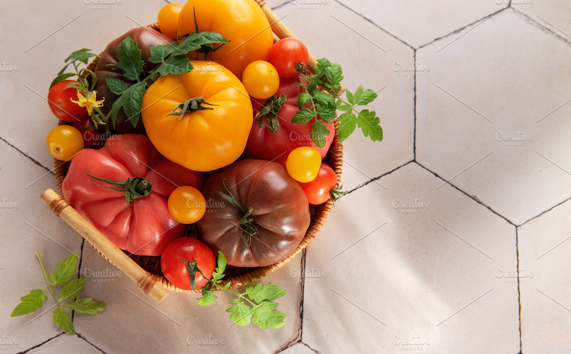 Heirloom tomatoes in basket showing harvest freshness, a Food & Drink Photo by Olena Rudo