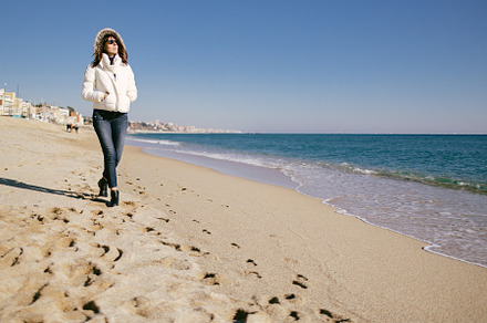 Woman walking on the beach, a Person Photo by TxemaG