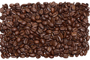Scattered roasted coffee beans on isolated background, top view, a Food & Drink Photo by ndanko