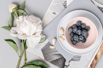 Peony and Earbuds on Grey Workspace, a Business Photo by Her Creative Studio