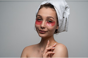 Young woman with a towel wrapped, a Health & Medical Photo by volodymyrshtun13795
