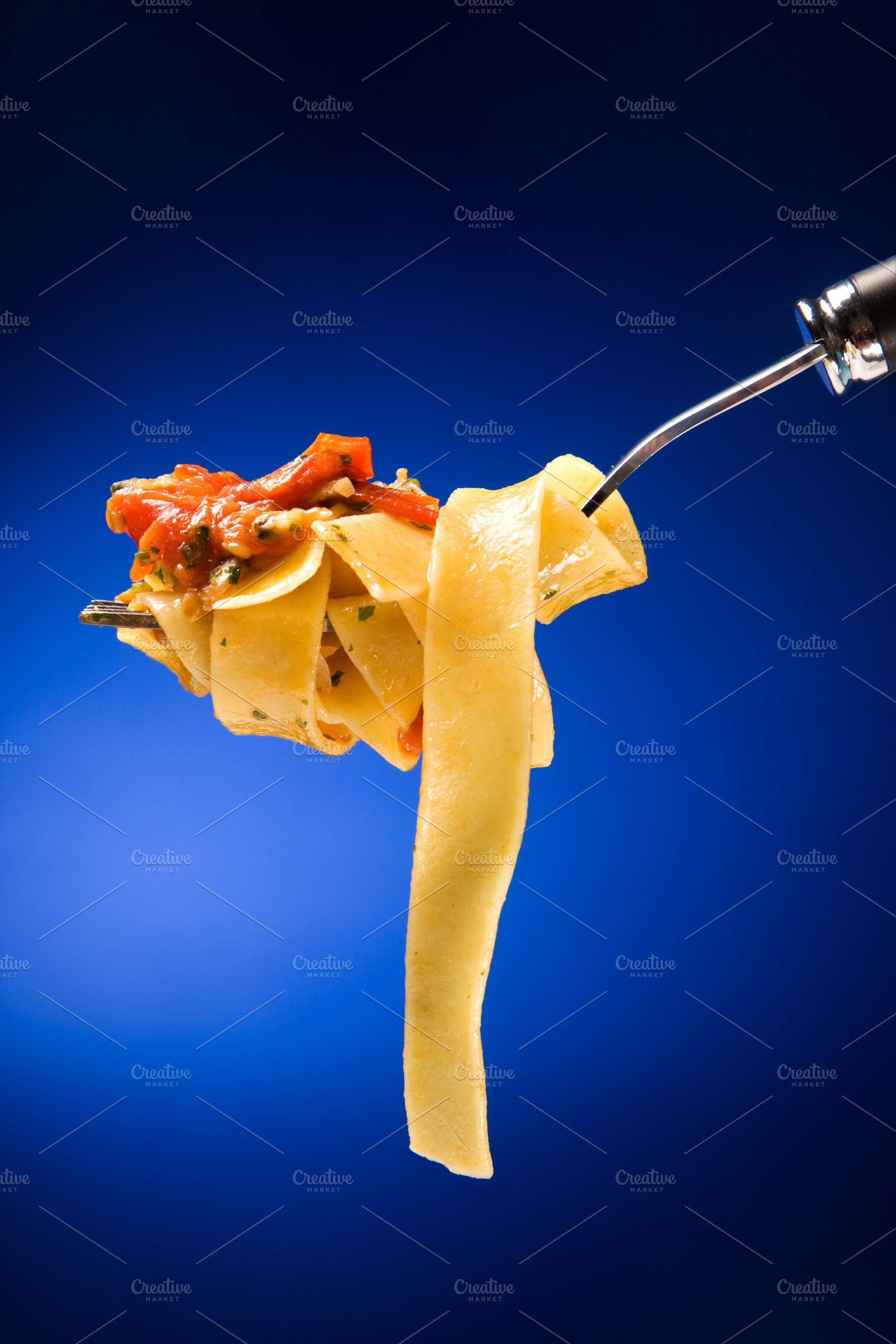 Tagliatelle with clams on a red background, a Food & Drink Photo by FoodStock