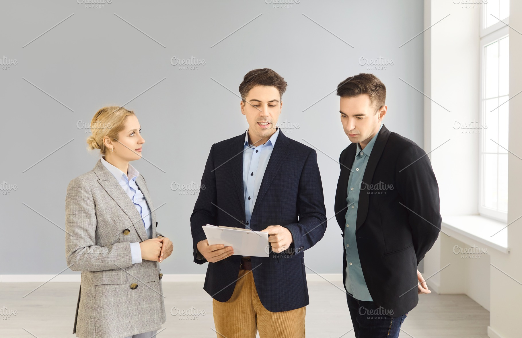 Realtor Briefing Couple on Papers, a Person Photo by StudioRomantic