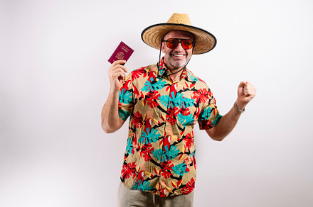 Joyful traveler showing Spanish passport and smiling