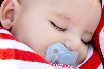 Adorable baby sleeping wrapped in a, a Person Photo by asife