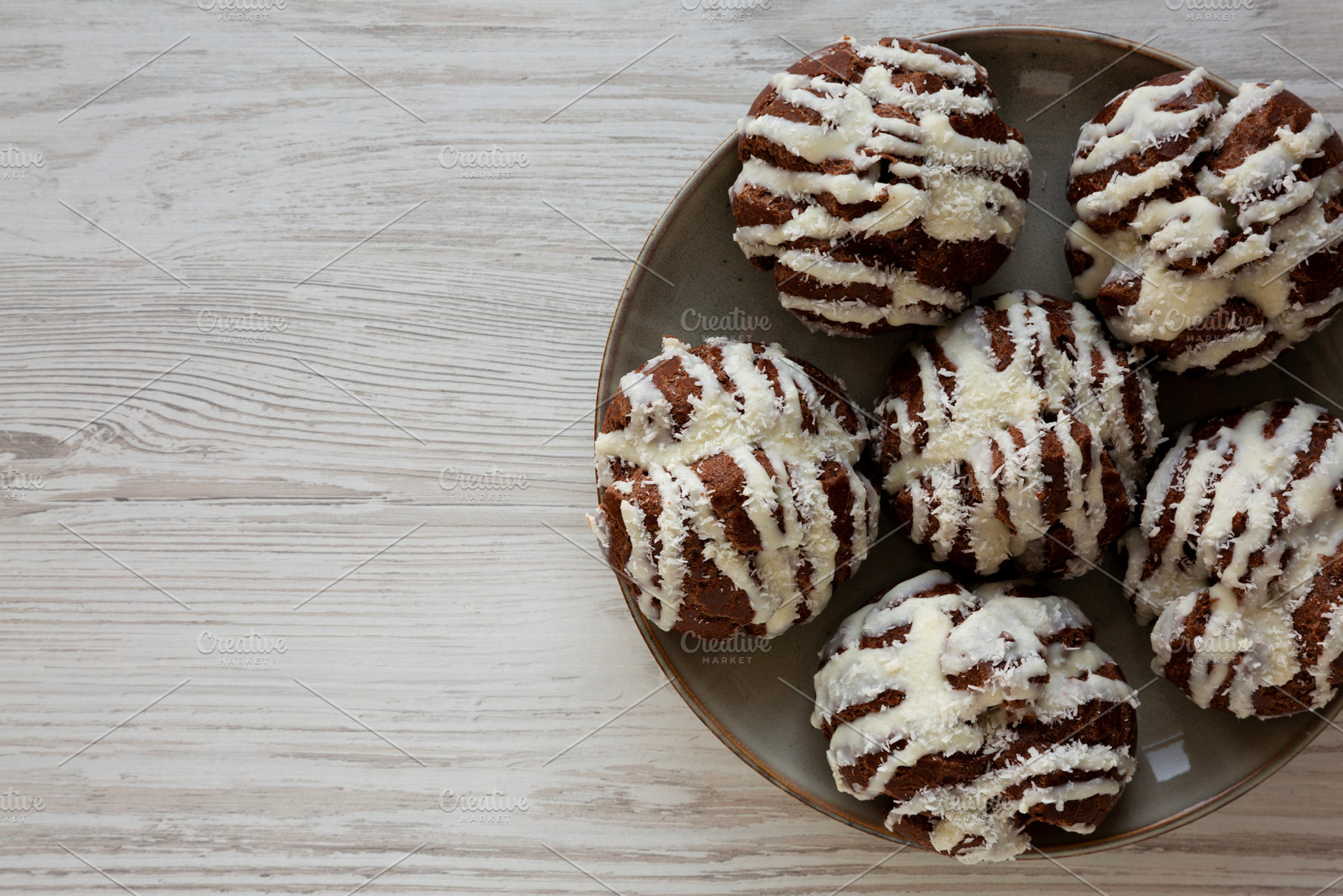 Homemade Profiteroles with Coconut Cream on a Plate, top view. C, a Food & Drink Photo by LiudmylaChuhunova