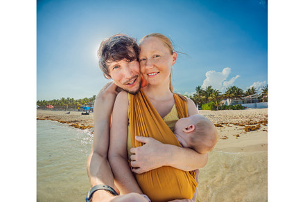 New parents cherish a beach day with, a Person Photo by Elizaveta Galitskaya