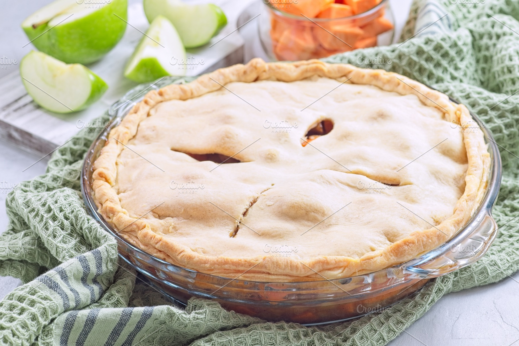 Freshly baked sweet potato and apple cobbler in glass baking dish, horizontal, a Food & Drink Photo by iuliia_n