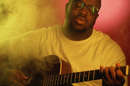 Guitar performer man playing neon li, a Person Photo by Photo Drive Studio