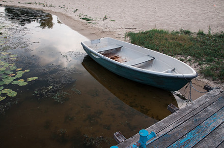 Old boat on an old wooden blue wharf on a river-lake. Top view,, a Transportation Photo by TanaCh