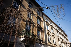 Historic buildings with balconies in sunlight against clear blue sky in Lviv, U, a Photo by AS photostudio