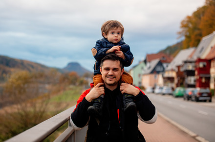 Father with son walking dawn the street, a Person Photo by Masson Simon