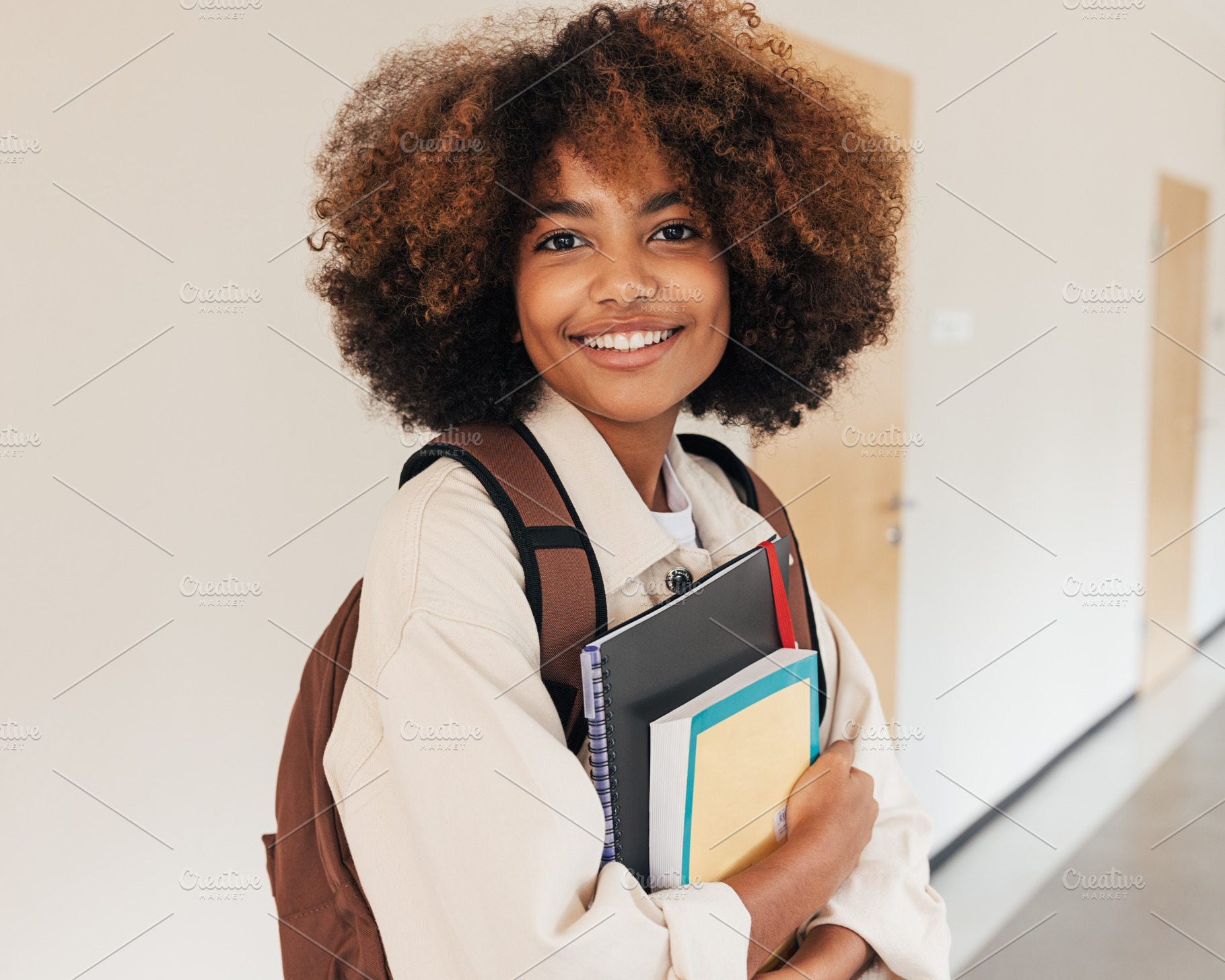 Student girl with books smiling, a Person Photo by Artem Varnitsin