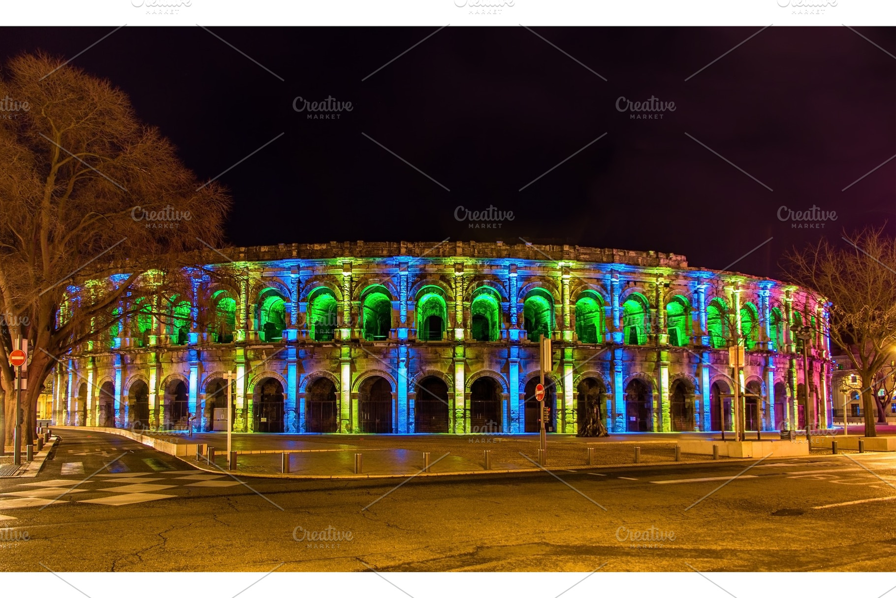 Roman amphitheatre arena of nimes in the evening france stock photo, an Architecture Photo by Leonid Andronov