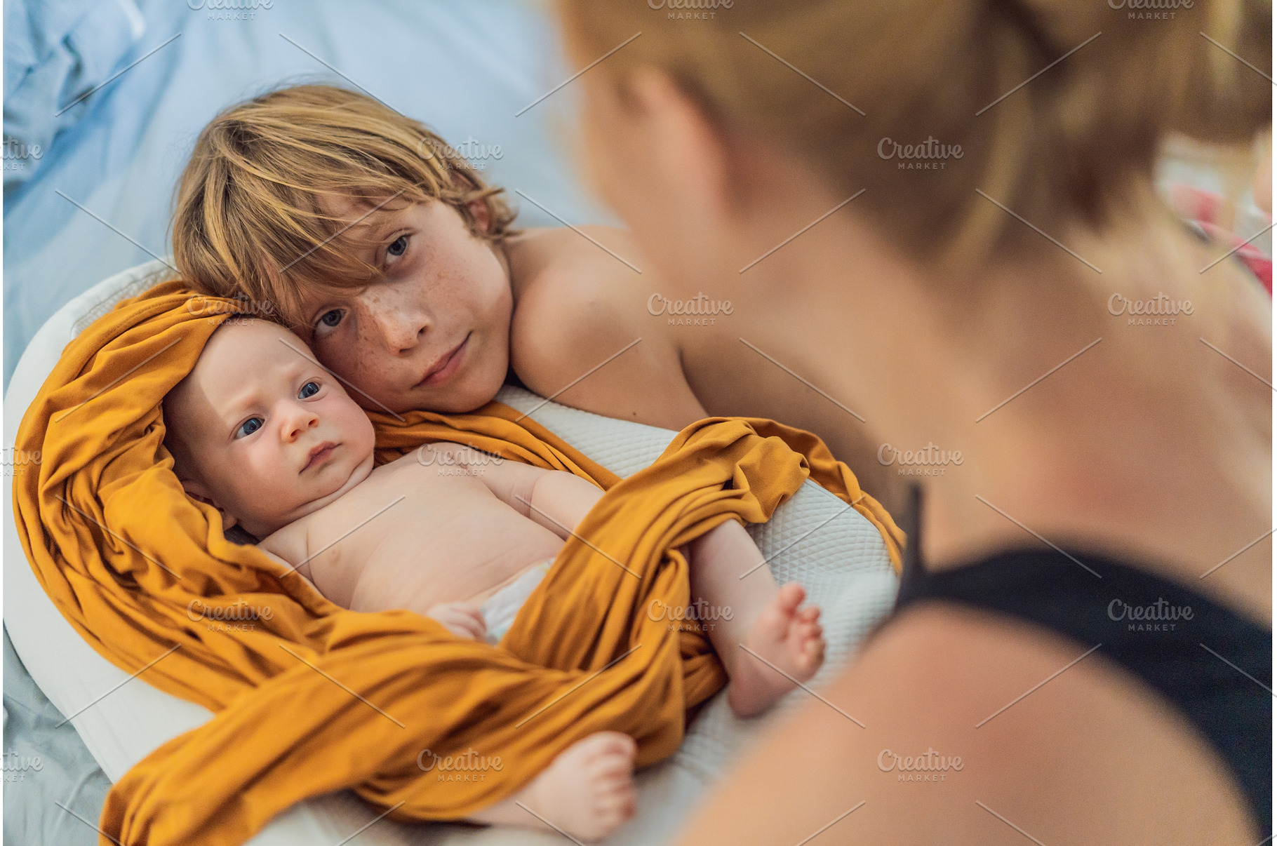 Older brother hugging his newborn, a Person Photo by Elizaveta Galitskaya