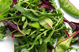 Fresh mixed salad greens creating healthy vegan food, a Food & Drink Photo by Olena Rudo