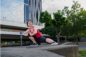 Woman working out in the city, doing, a Graphic by HalfPoint