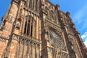 Strasbourg Cathedral facade under bright blue summer sky, an Architecture Photo by GoodGoods