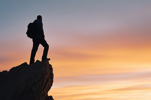 Silhouette of a hiker standing on a, a Person Photo by MistyDay