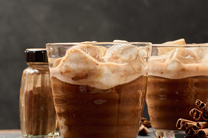 Glasses of hot chocolate with fluffy marshmallows on a wooden ta, a Food & Drink Photo by ndanko