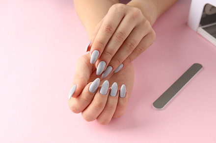 Concept of nail care with female hands on pink background, a Beauty & Fashion Photo by AtlasStudio