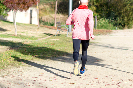 Senior man jogging in the park on a sunny day