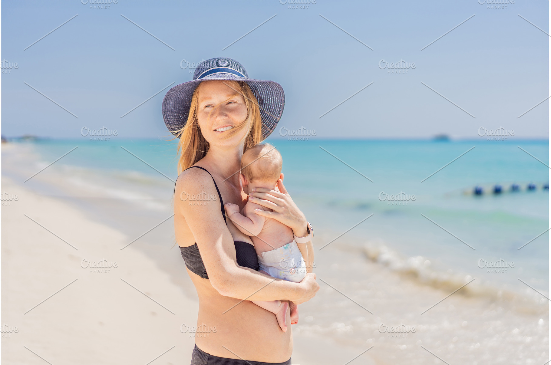 Mother holding her newborn baby by, a Person Photo by Elizaveta Galitskaya