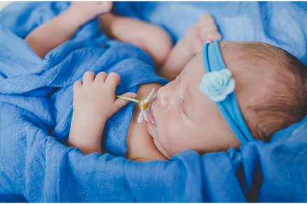 Newborn baby sleeping on a blue, a Person Photo by yanadjana