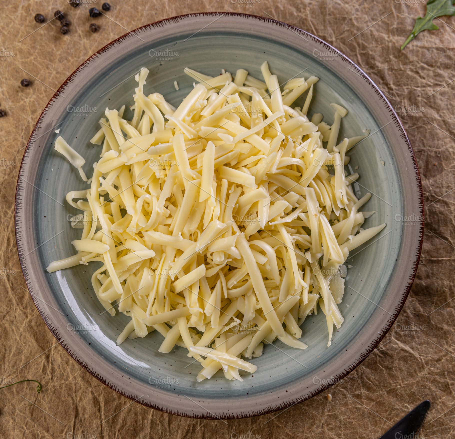 Shredded cheese waiting in a plate, a Photo by Grafvision photography