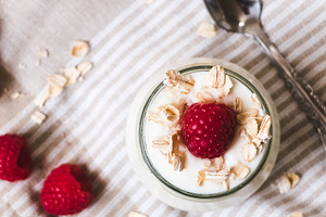 Yogurt with raspberries containing breakfast, food, and fruit