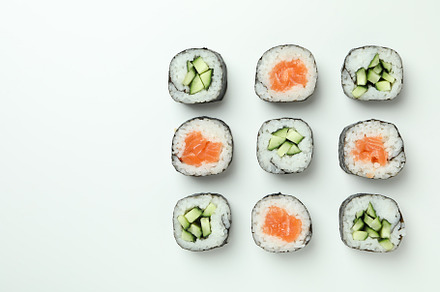 Concept of tasty food with sushi rolls on white background, a Food & Drink Photo by AtlasStudio