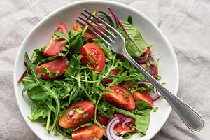 Fresh garden salad with tomatoes, arugula, and onion, a Photo by Olena Rudo