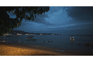 Calm beach at night with boats and, a Nature Photo by Our Amazing World