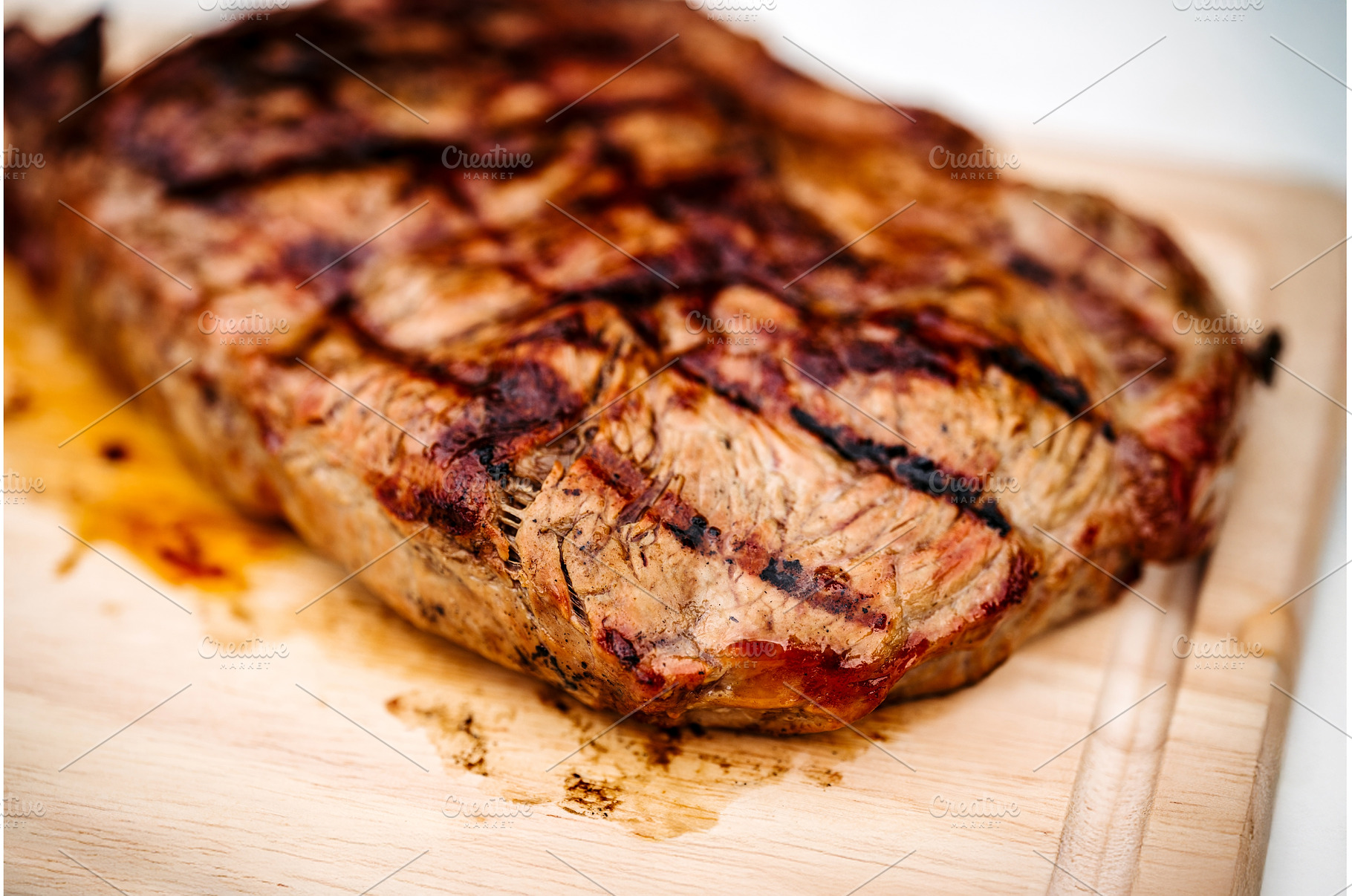 Close up of steak from grill on, a Food & Drink Photo by HalfPoint