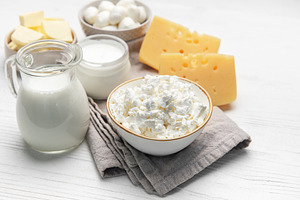 Dairy products assortment displaying milk, various cheeses, and, a Food & Drink Photo by Olena Rudo