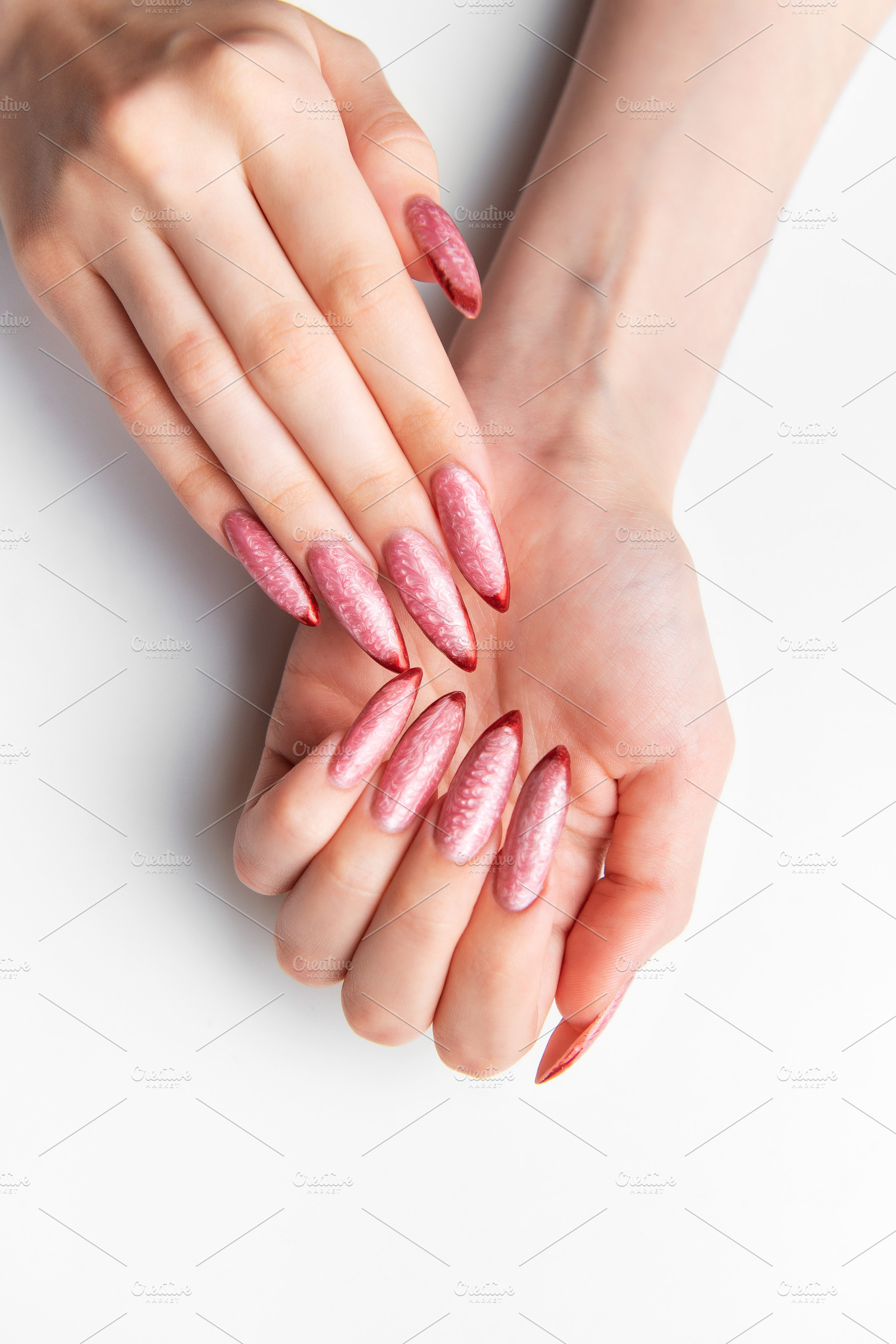 Woman's hands showing long pink glitter stiletto nails, a Beauty & Fashion Photo by Olena Rudo
