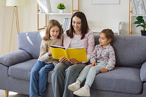 Mother and Kids Reading a Book, a Person Photo by StudioRomantic