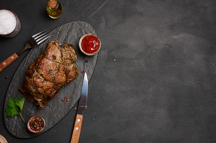 Baked pork collar with spices on a wooden board, delicious and j, a Food & Drink Photo by ndanko