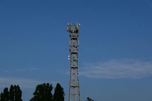 communication tower mast over blue sky, a Photo by WorldOfPhotos