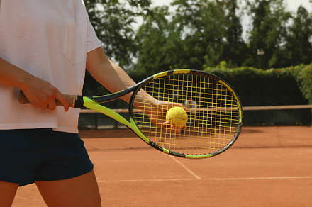 Woman hold racket and tennis ball on clay court, a Sports & Recreation Photo by AtlasStudio PRO