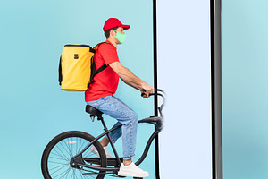 Courier On Bike Riding Into Huge Cellphone Screen, Blue Background, a Photo by Prostock-Studio