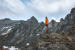 Man hiking solo in rocky mountains travel adventure outdoor activity summer vac