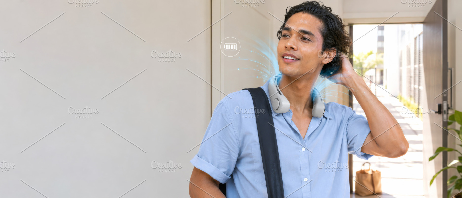 Young man using wearable cooling dev, a Photo by Dvoevnore photos